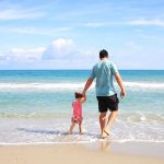 Dad and child on the beach