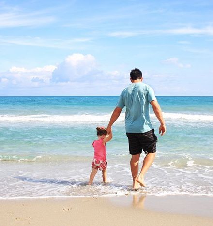 Dad and child on the beach