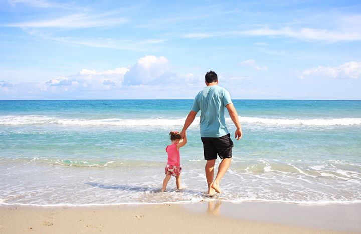 Dad and child on the beach